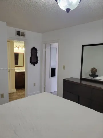 a bedroom with a bed and cabinets