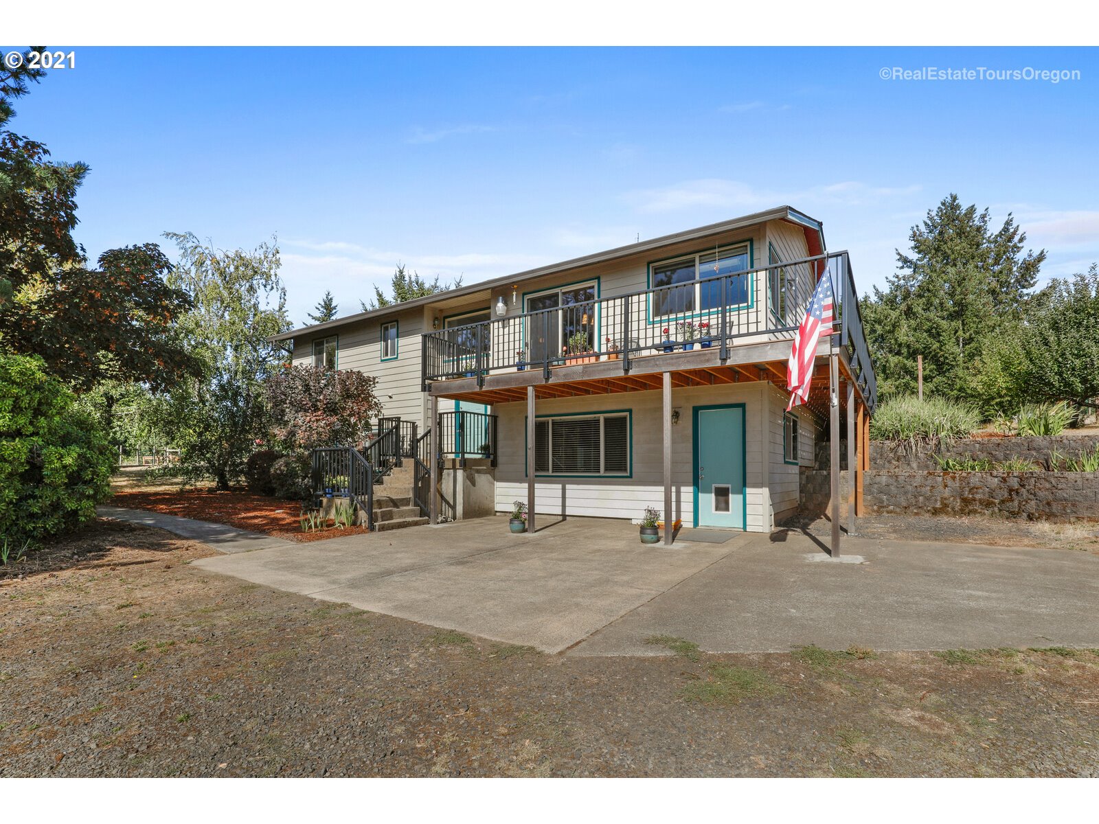 40965 Southwest Vandehey Road Gaston, OR 97119 - Photo 1 of 32 a front view of a house with a garden