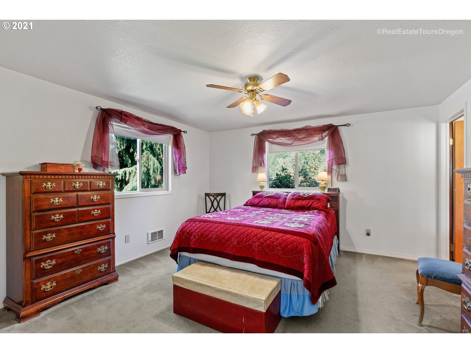 40965 Southwest Vandehey Road Gaston, OR 97119 - Photo 11 of 32 a bedroom with a bed and a chandelier