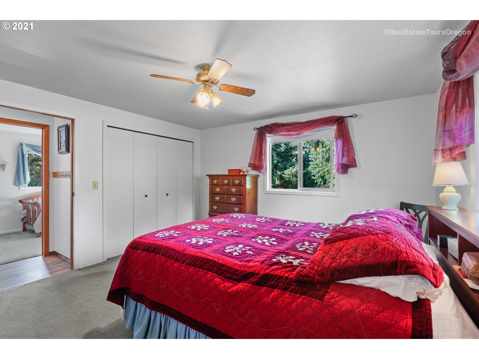 40965 Southwest Vandehey Road Gaston, OR 97119 - Photo 12 of 32 a bedroom with a bed and a chandelier