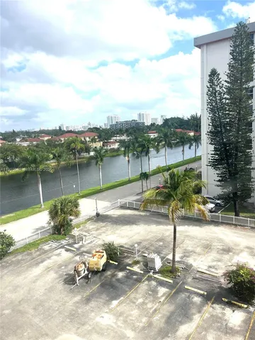 a view of a lake with a car parked on the roadside