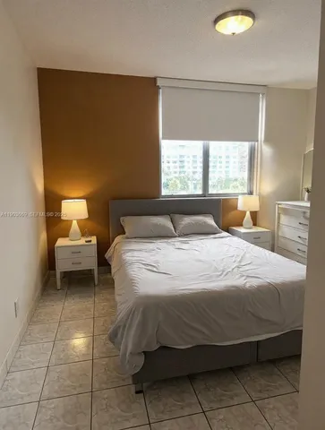 a bedroom with a bed and a chair