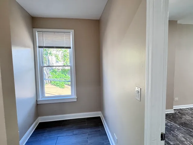 a view of room with window and hardwood floor