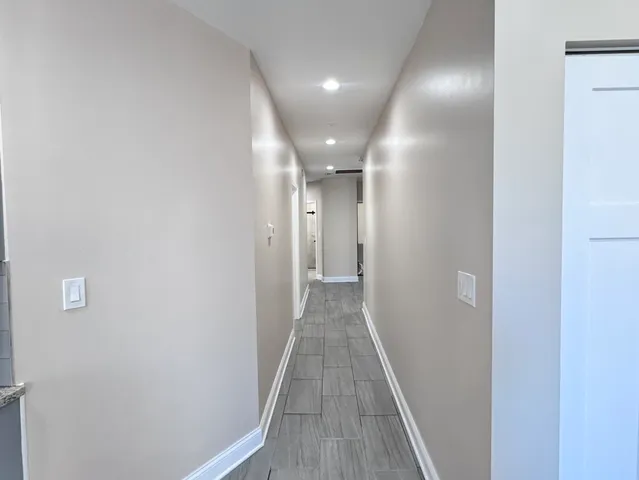 a view of a hallway with wooden floor