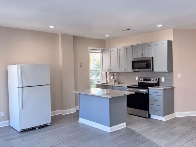 a kitchen with a refrigerator stove and microwave