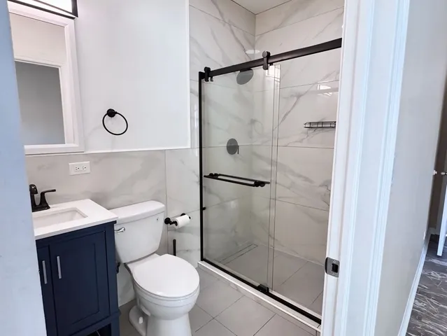 a bathroom with a toilet a sink and a shower