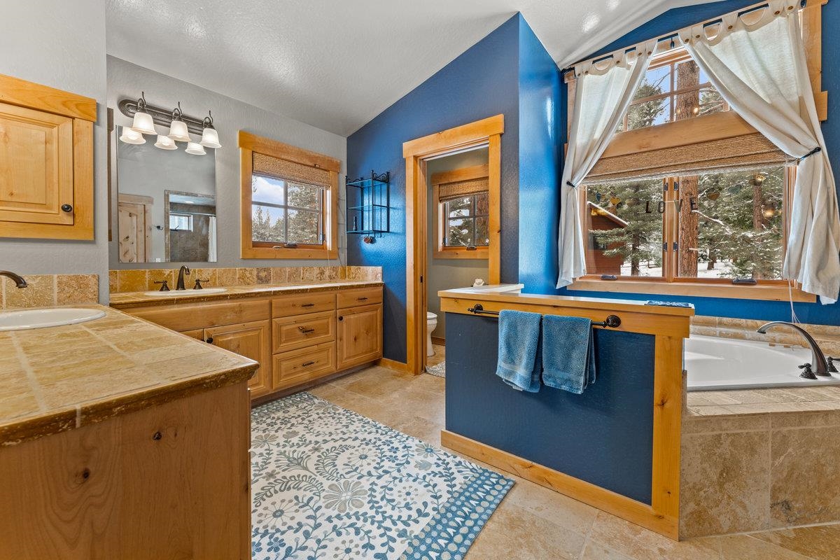 424 Chipmunk Street Kings Beach, CA 96143 - Photo 12 of 21 a kitchen with stainless steel appliances kitchen island granite countertop a sink and wooden cabinets