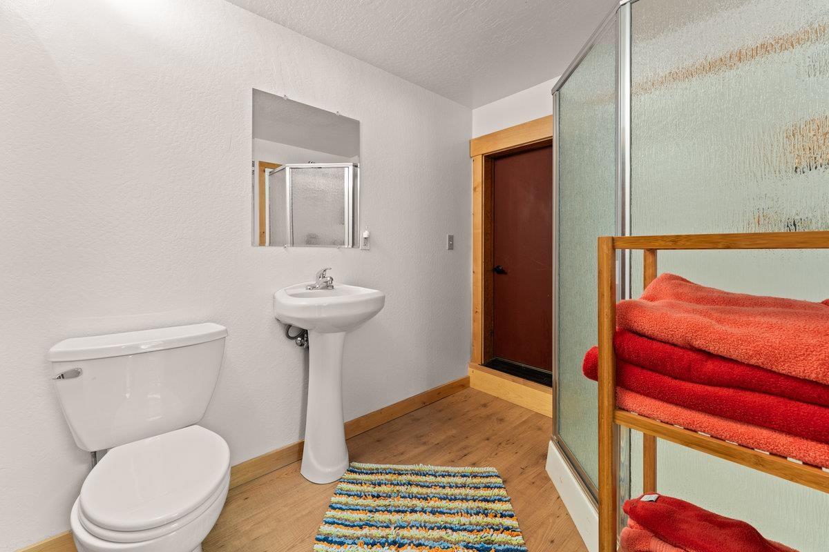424 Chipmunk Street Kings Beach, CA 96143 - Photo 19 of 21 a bathroom with a toilet a sink and mirror