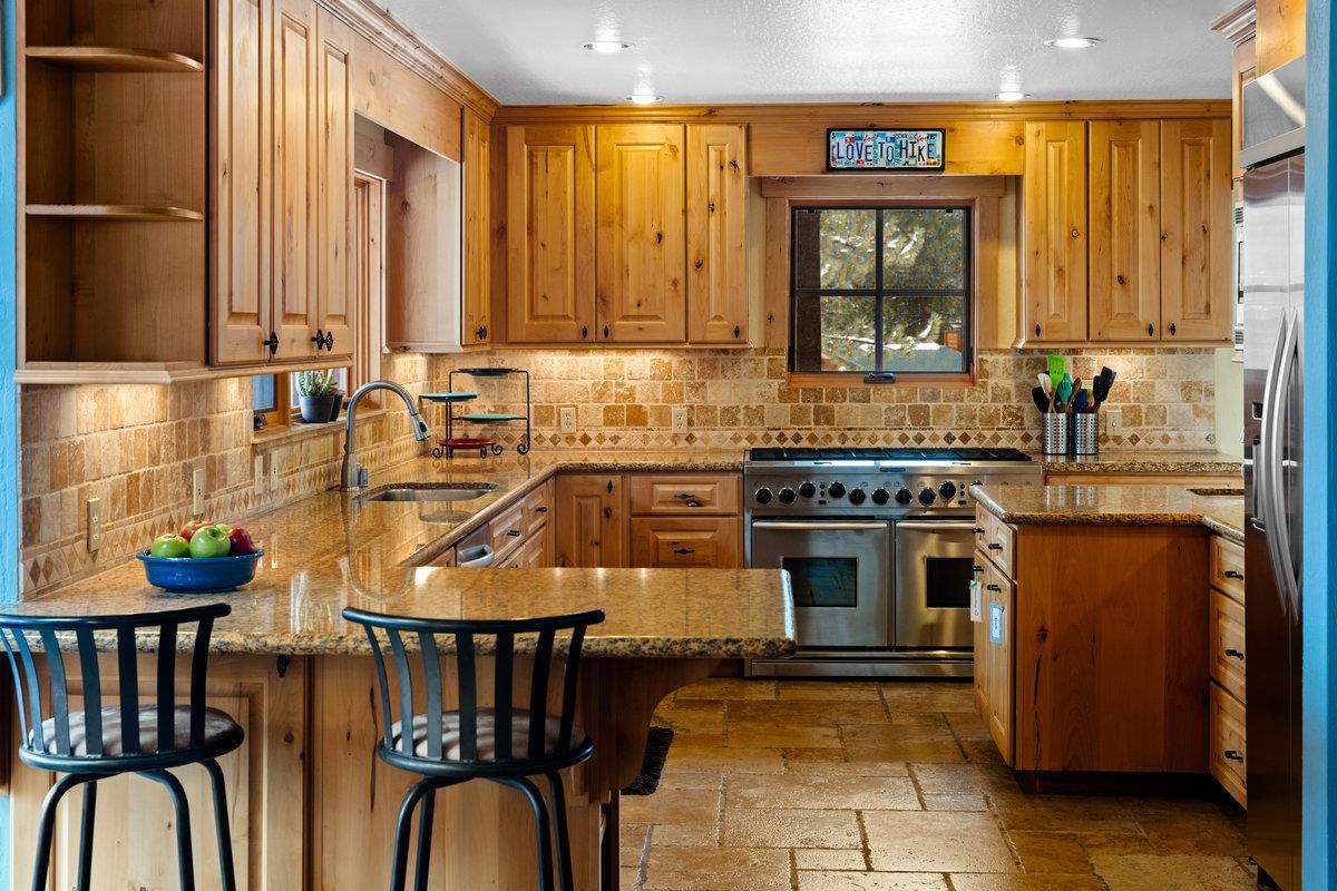 424 Chipmunk Street Kings Beach, CA 96143 - Photo 9 of 21 a kitchen with stainless steel appliances granite countertop a stove a sink and a microwave
