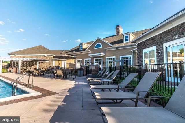 a view of a swimming pool with an outdoor seating and a yard