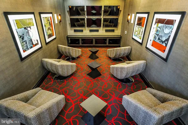 a view of a dining room with a table and chairs