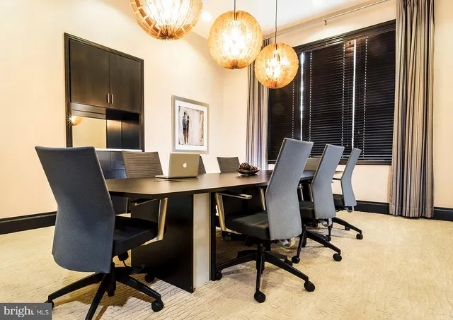 a view of a workspace with furniture and a window