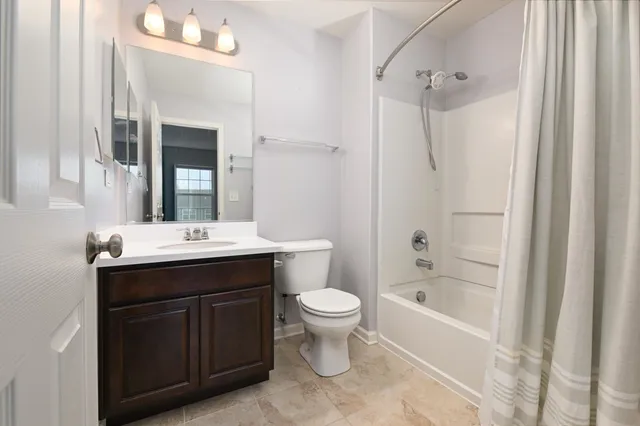 a bathroom with a sink toilet tub and shower
