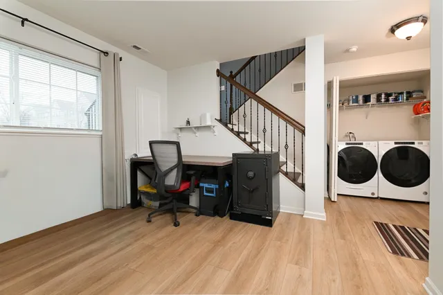 a view of a room with wooden floor and furniture