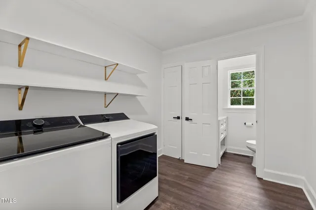 a kitchen with a stove and a wooden floor