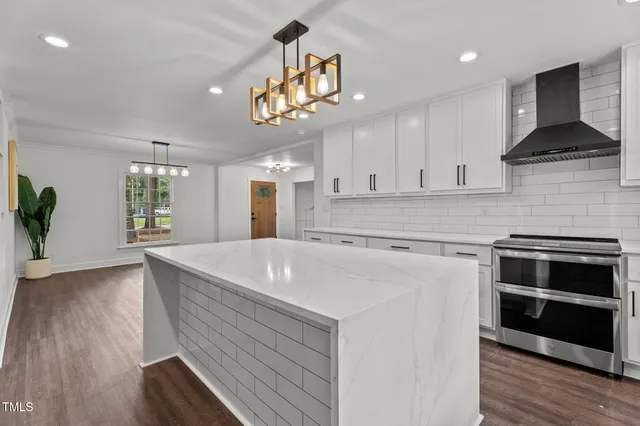 a kitchen with cabinets a sink and stainless steel appliances