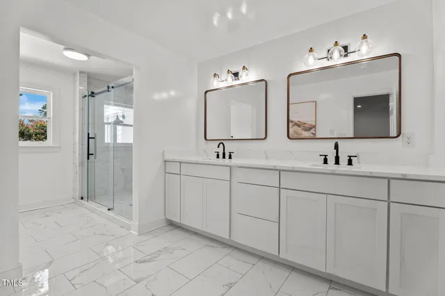 a bathroom with 2 sink and a mirror