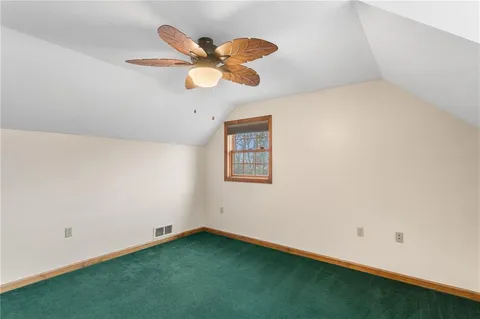 a view of an empty room with a ceiling fan