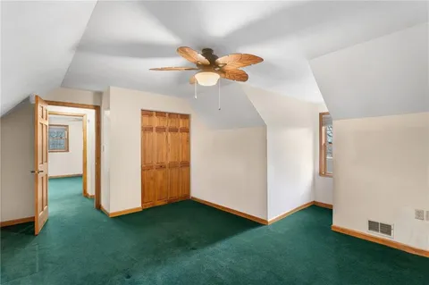 a view of an empty room with a ceiling fan