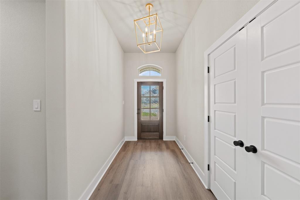 9824 Durango Trail Waco, TX 76712 - Photo 15 of 30 Doorway to outside with a chandelier and wood finished floors