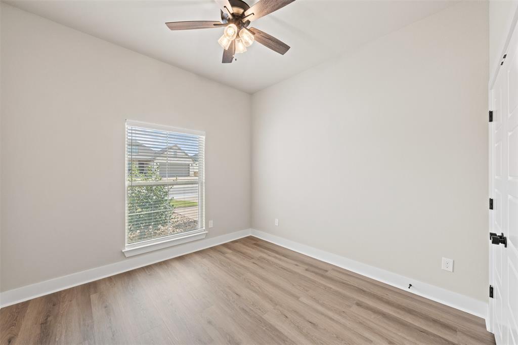 9824 Durango Trail Waco, TX 76712 - Photo 16 of 30 Empty room with light wood finished floors and a ceiling fan