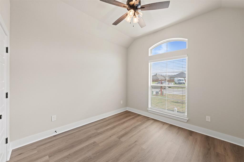 9824 Durango Trail Waco, TX 76712 - Photo 18 of 30 Empty room with lofted ceiling, light wood-style floors, and ceiling fan