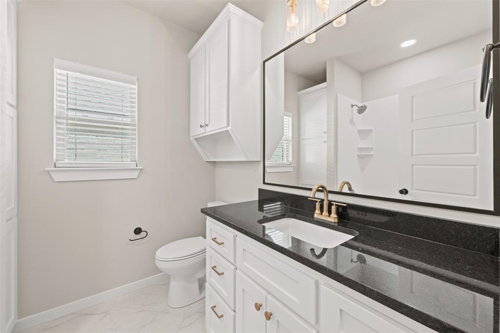 9824 Durango Trail Waco, TX 76712 - Photo 20 of 30 Bathroom with vanity, light marble finish floors, and a shower