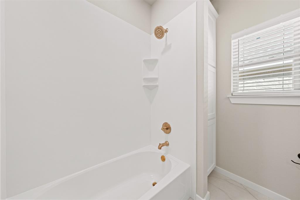 9824 Durango Trail Waco, TX 76712 - Photo 21 of 30 Bathroom featuring shower / tub combination and light marble finish flooring
