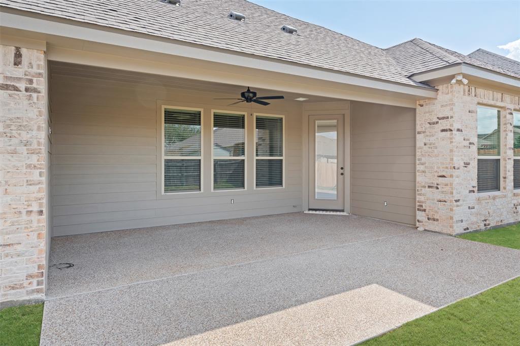 9824 Durango Trail Waco, TX 76712 - Photo 28 of 30 Doorway to property with ceiling fan, a patio, and roof with shingles