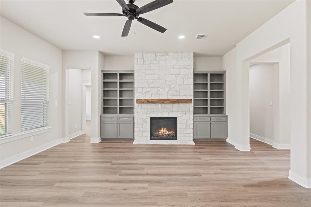 9824 Durango Trail Waco, TX 76712 - Photo 6 of 30 Unfurnished living room featuring a ceiling fan, a stone fireplace, light wood-style flooring, and recessed lighting