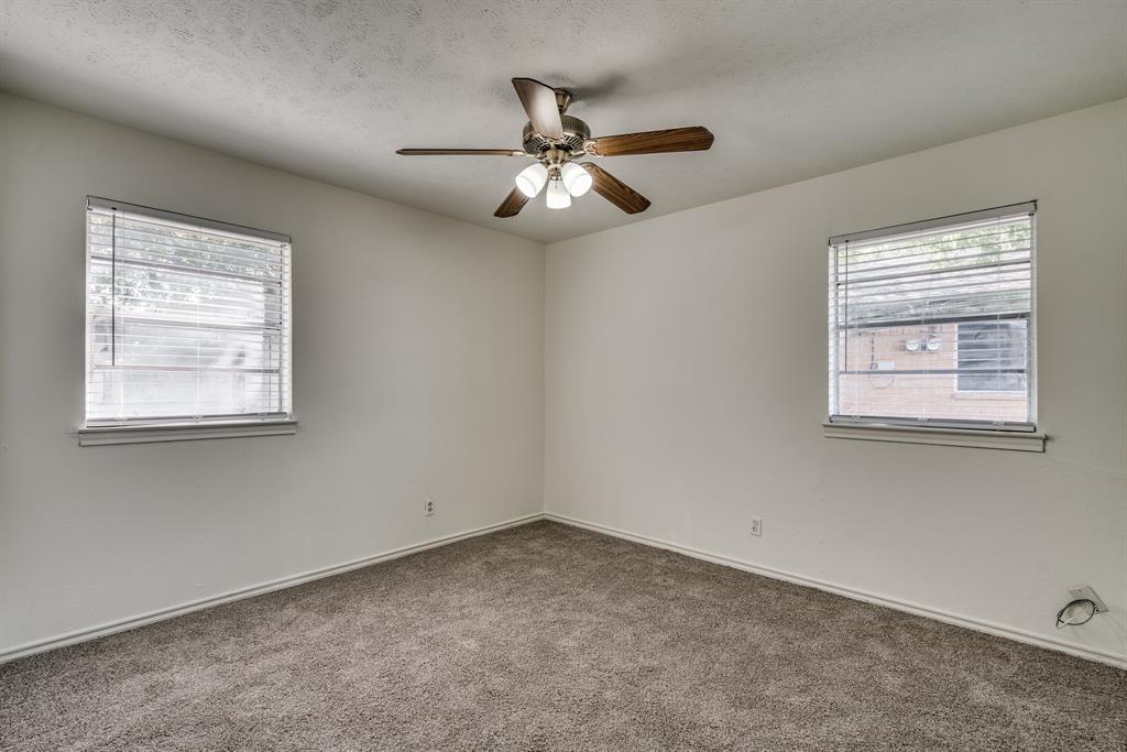 116 North 12th Street, Unit B Midlothian, TX 76065 - Photo 14 of 24 an empty room with windows and fan
