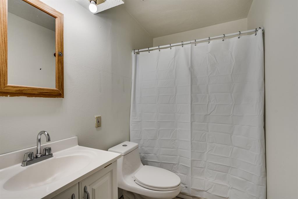 116 North 12th Street, Unit B Midlothian, TX 76065 - Photo 19 of 24 a bathroom with a sink a toilet and shower