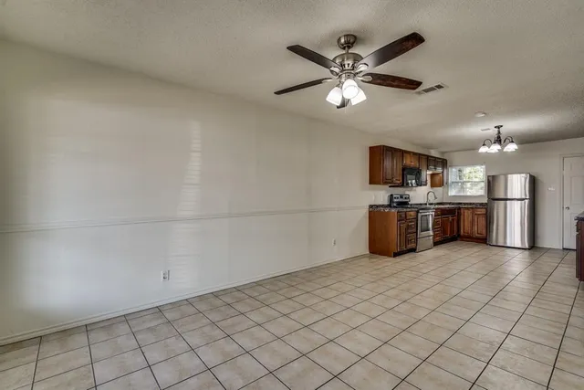 a view of a kitchen with a sink cabinets and stainless steel appliances