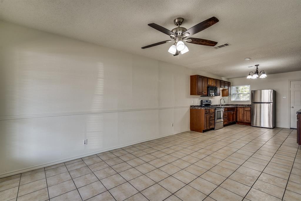 116 North 12th Street, Unit B Midlothian, TX 76065 - Photo 23 of 24 a view of a kitchen with a sink cabinets and stainless steel appliances