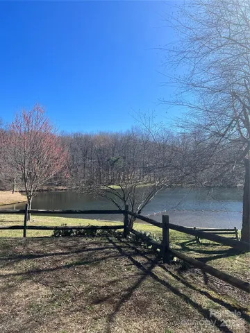 a view of a yard with wooden fence