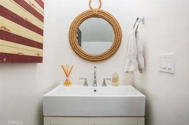 a bathroom with a sink a mirror and a toilet