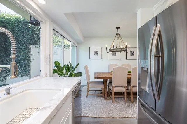 a dining room with furniture a chandelier and a rug