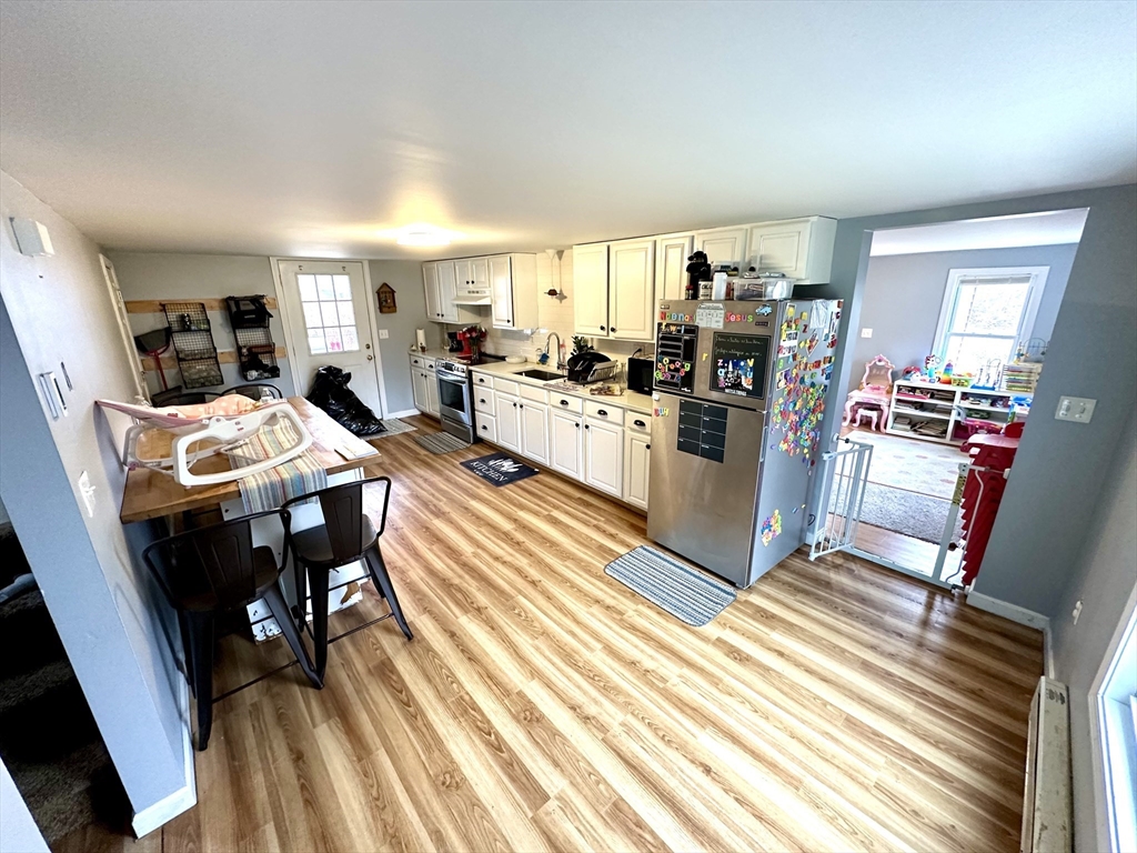 76 Everton Avenue Worcester, MA 01604 - Photo 13 of 38 a living room with stainless steel appliances furniture and a table