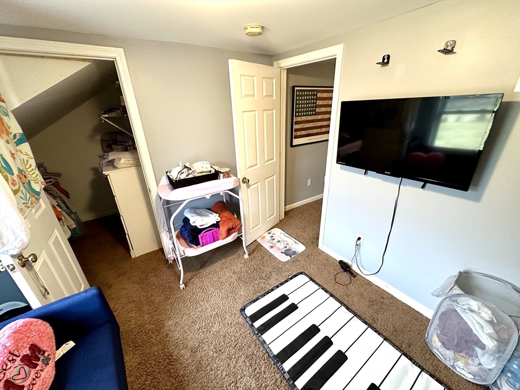 76 Everton Avenue Worcester, MA 01604 - Photo 21 of 38 a living room with furniture and a flat screen tv