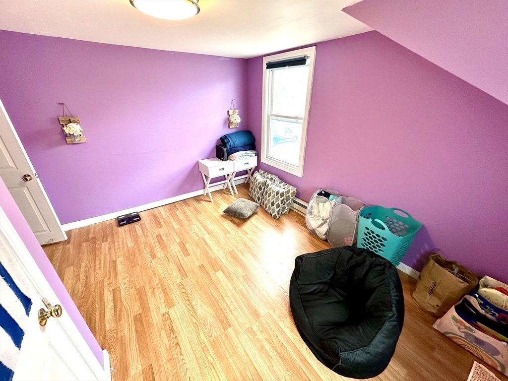 76 Everton Avenue Worcester, MA 01604 - Photo 23 of 38 a bedroom with a bed and a chair