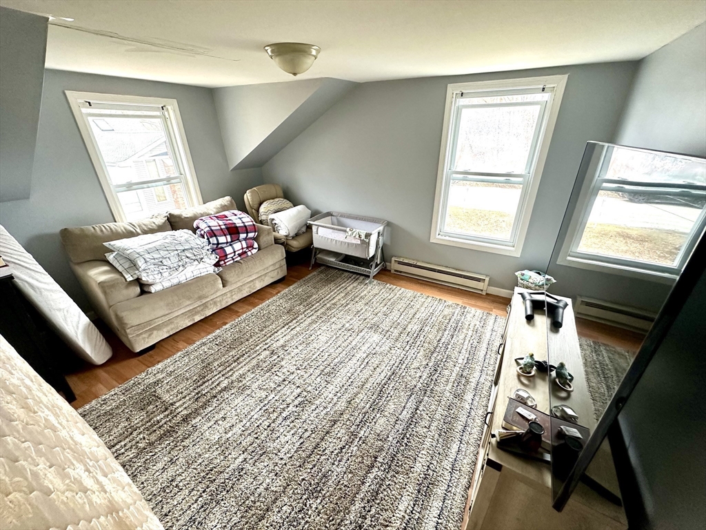 76 Everton Avenue Worcester, MA 01604 - Photo 24 of 38 a living room with a couch and a window