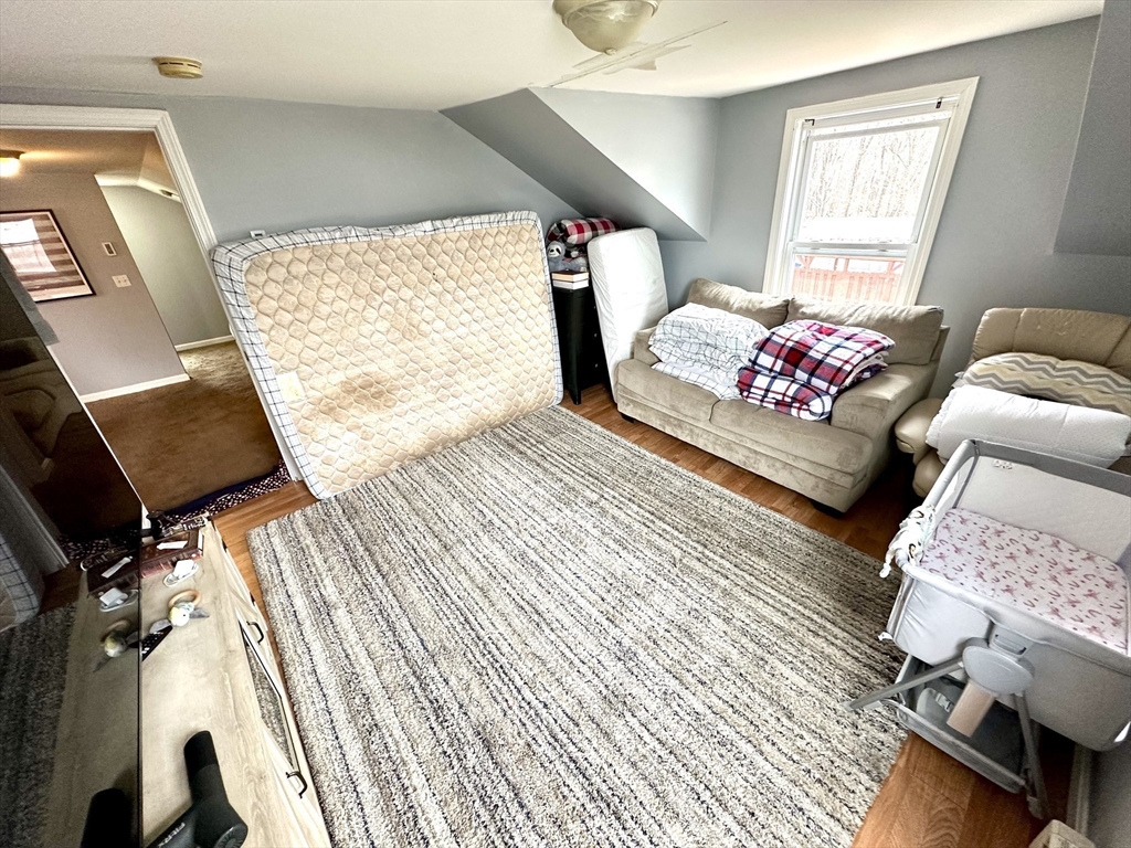 76 Everton Avenue Worcester, MA 01604 - Photo 25 of 38 a bedroom with a bed and wooden floor