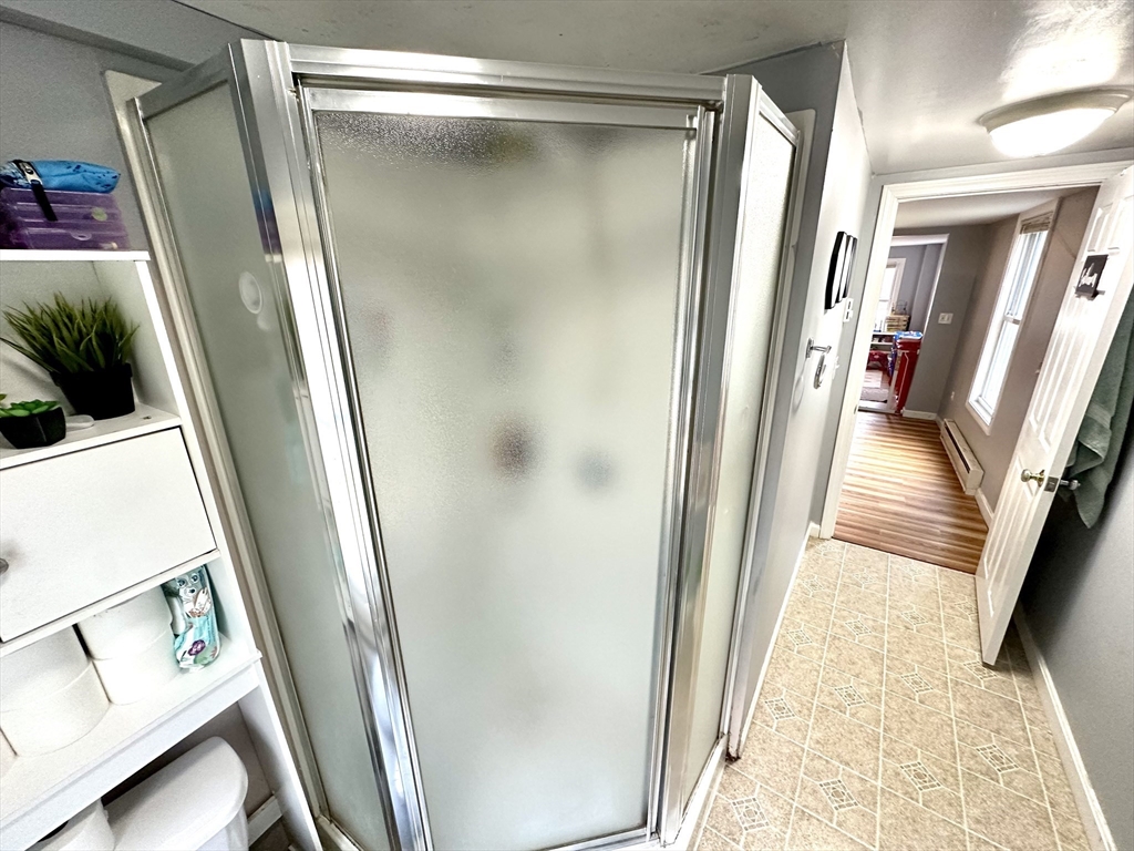 76 Everton Avenue Worcester, MA 01604 - Photo 29 of 38 a view of a hallway with wooden floor and stairs