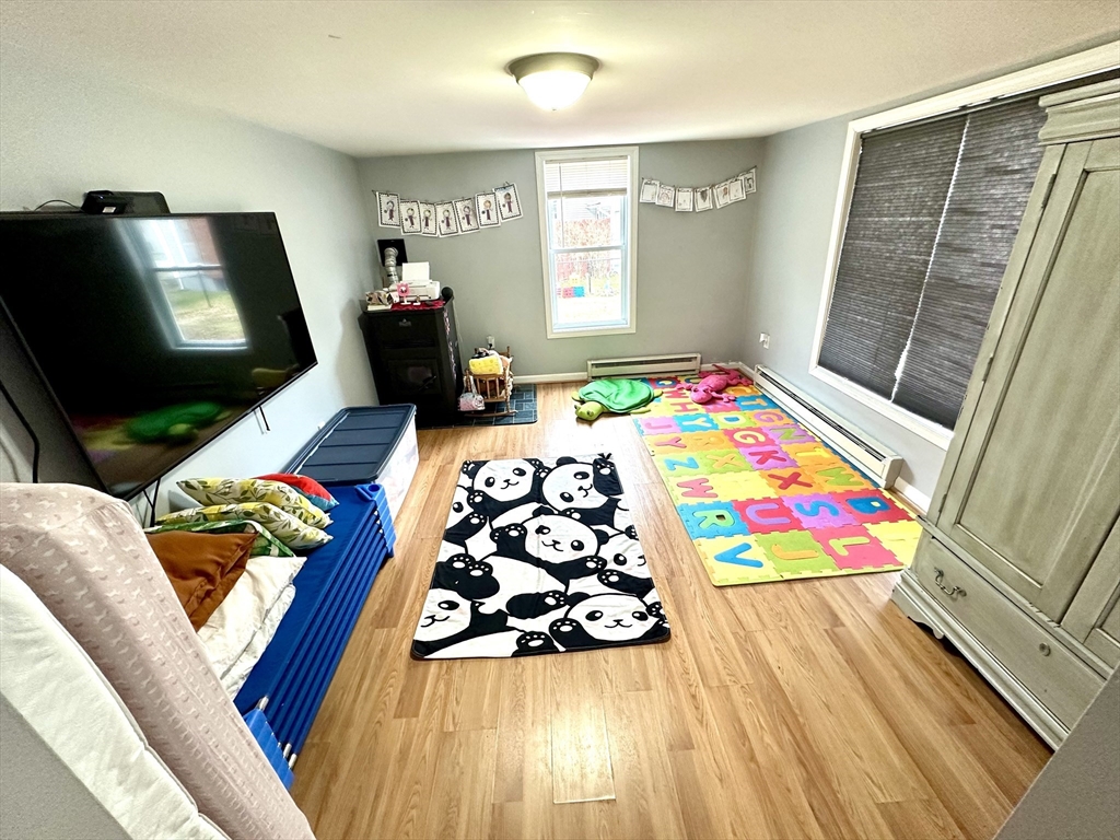 76 Everton Avenue Worcester, MA 01604 - Photo 8 of 38 a bedroom with furniture and a flat screen tv