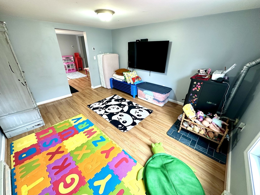 76 Everton Avenue Worcester, MA 01604 - Photo 10 of 38 a living room filled with furniture and a flat screen tv