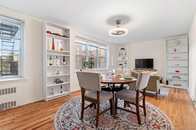 a view of a dining room with furniture window and wooden floor