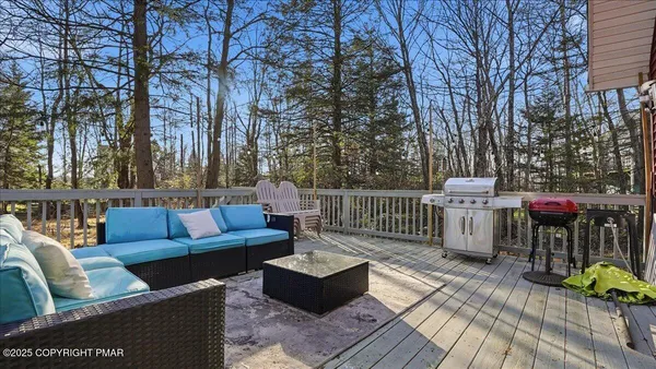 a front view of house with deck and outdoor seating
