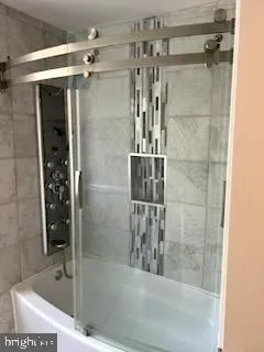 a bathroom with a shower and a sink