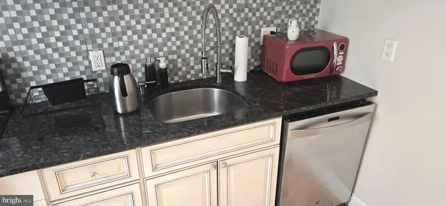 a kitchen with a sink and a stove