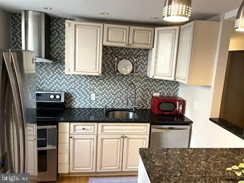 a kitchen with stainless steel appliances granite countertop a stove and a refrigerator